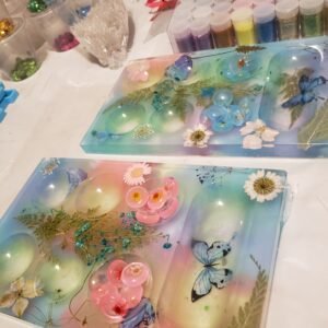 pink and blue mancala board with flowers and butterflies