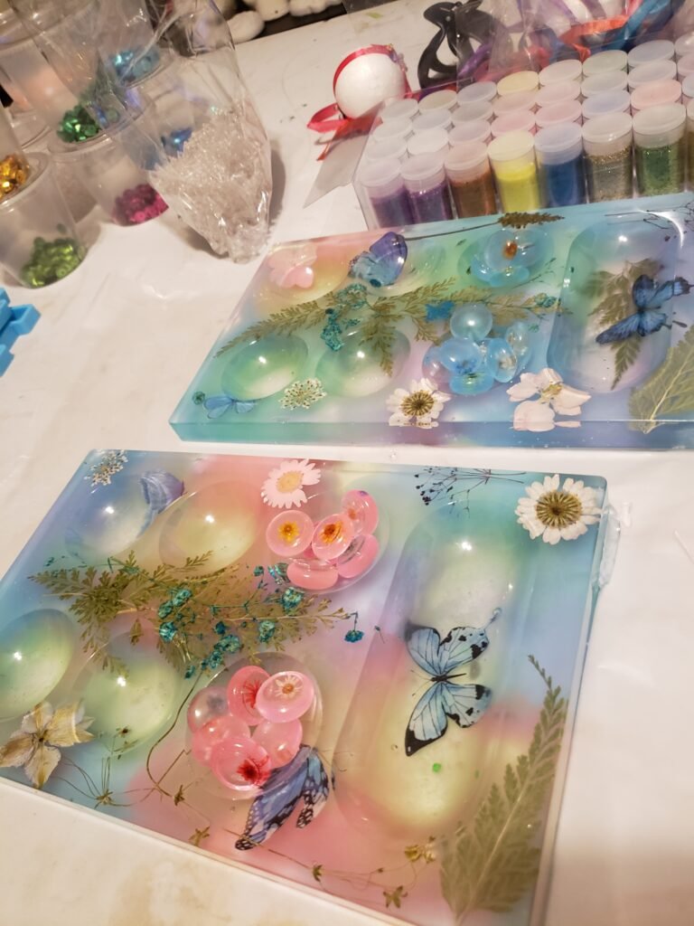 pink and blue mancala board with flowers and butterflies